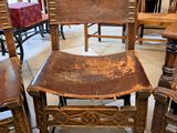 several wooden chairs are lined up in a room with a table and chairs