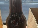 a bottle of soda sitting on a table next to a box