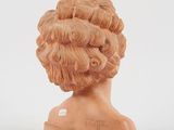 a sculpture of a woman ' s head on a white surface