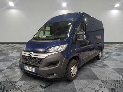 the blue van is parked on a checkered floor in the garage