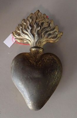 a heart shaped object on a table with a tag attached to it