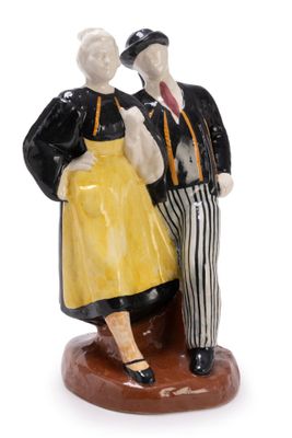 a figurine of a man and a woman standing on a pedestal