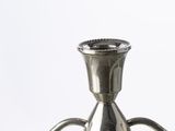 a silver metal candle holder on a white background
