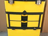 a yellow and black box that has a black handle on it