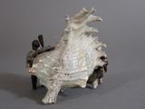 a figurine of a man riding a horse on a shell