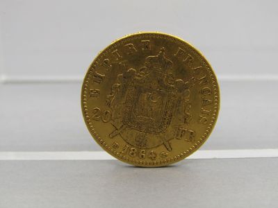 a close up of a gold coin on a white surface