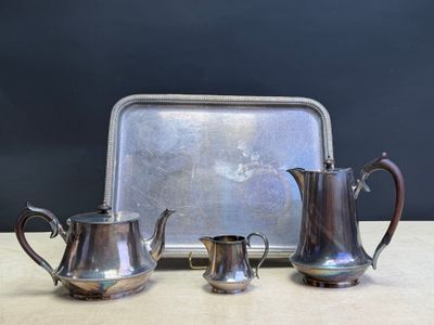 three pieces of silverware sitting on top of a table next to a tray