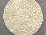 a close up of a silver coin on a black surface