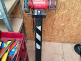 a red machine that is sitting in a garage