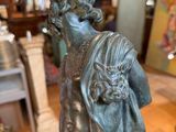 bronze statue of a boy with a backpack on a marble base