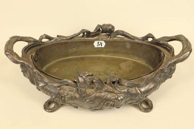 an antique silver plate with a bird design on it