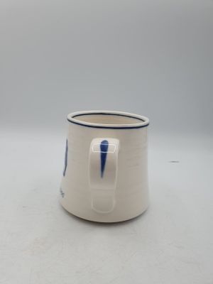 une tasse blanche avec une rayure bleue