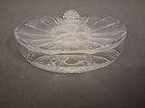 a glass bowl with a statue on it on a table