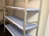 a metal shelf with blue shelves in a room