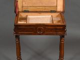 an old wooden writing desk with a drawer on top of it
