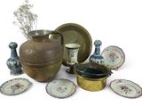 many different types of vases and plates on the table