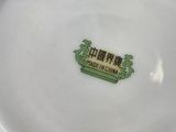 a white plate with a green and yellow design on it