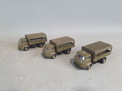 four toy army vehicles that are sitting on a table
