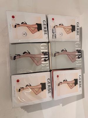 six pairs of women ' s stockings are on display in a display case