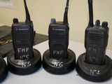 four walkie talkies sitting on top of each other