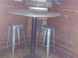 a small table and two stools in the corner of a room