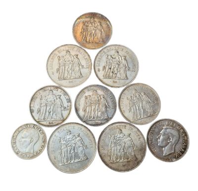 a close up of a pyramid of coins on a white surface