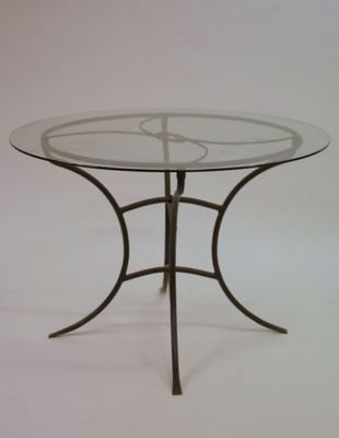 une table en verre avec une base en métal et un plateau en verre