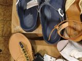 many pairs of shoes that are sitting on a wooden box