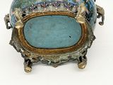 an image of a blue and gold vase on a stand