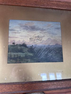 a picture of a painting hanging on a wall above a clock