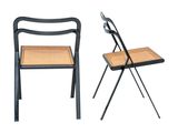 a pair of chairs sitting next to each other on a white surface
