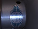 a close up of a metal object with a blue sticker on it