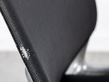 the back of a black chair with a zipper on it