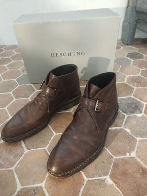 men ' s brown leather shoes with a box on the floor