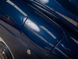 a close up of a blue car parked in a parking lot