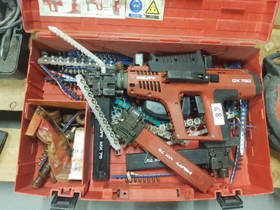a red tool box with a chainsaw and other tools in it