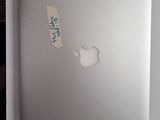a sticker on the back of an apple laptop
