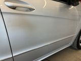 a silver car that is parked in a garage