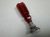 an image of a silver and red object on a white surface
