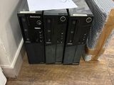 three computers that are sitting on top of each other