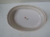 a white plate with a flower on it on a table