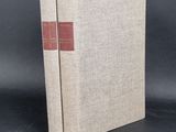 a book with a red cover sitting on top of a table
