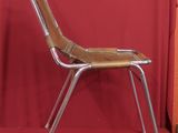 a chair that is sitting in front of a red curtain
