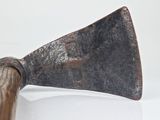 an old rusty axe with a wooden handle on a white surface