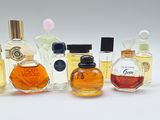 several different types of perfume bottles lined up on a white surface
