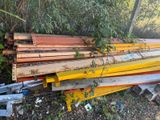 a pile of wood sitting on the ground next to a fence