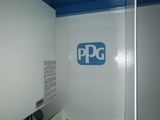 a white toilet with a black toilet seat and a blue ceiling