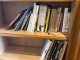 a bookshelf with many books on it in a room
