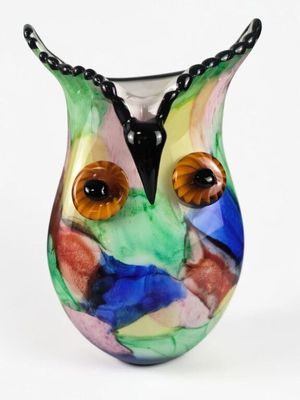 a colorful glass vase with an owl face on it