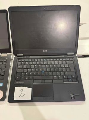 two laptops sitting next to each other on a table